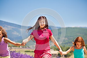 Girl running with her friends in lavender field