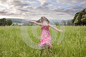 Girl running through long grass