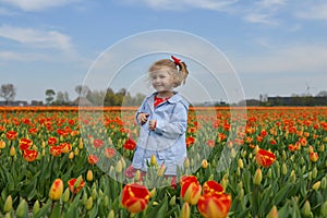 Girl running in a orange tulip field