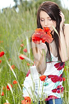 Girl running in poppy field