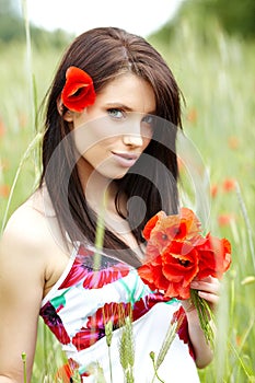 Girl running in poppy field