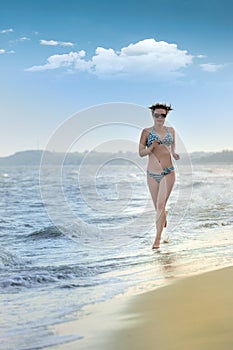 The girl running on seacoast