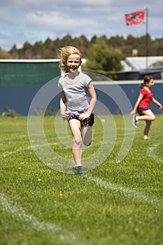 Girl running in sports race.