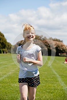 Girl running in sports race.