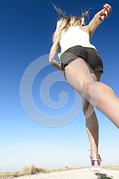 Girl running under the blue sky