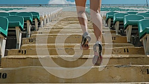 Girl running upstairs at a stadium. Close-up