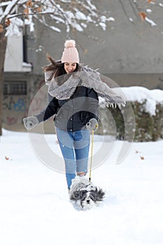 A girl is running whit cute shih tzu dog