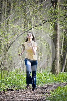 Girl running in woods