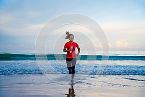 Girl running workout jogging on the beach in the morning. relax and happy with running on the sea. in summer