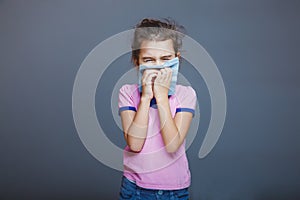 Girl with a runny nose pressed handkerchief to her