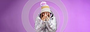 Girl runny nose sneeze tissue press napkin face got ill feeling unwell sick heading hospital standing purple background