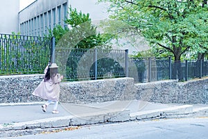 girl runs along the fence