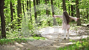 Girl runs along a forest road