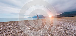 The girl runs along the sandy beach