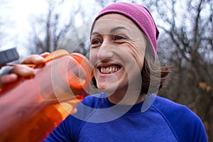 Girl drinks water after jogging