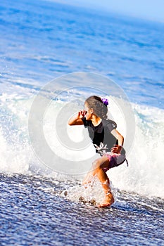 Girl runs from big waves