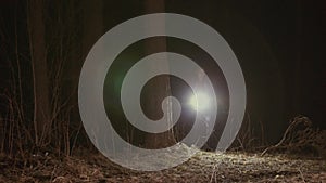 Girl runs through a dark forest with a lantern