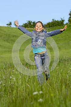 Girl runs on a grass
