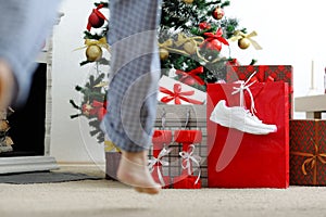 Girl runs to the Christmas tree for gifts.