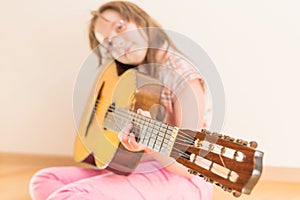 Girl with russian seven-string acoustic guitar