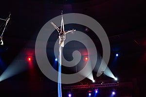 Girl`s aerial acrobatics in the Circus arena.