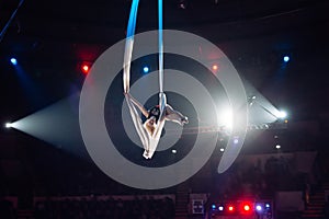 Girl`s aerial acrobatics in the Circus ring.