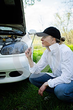 The girl`s car broke down, vehicle repair