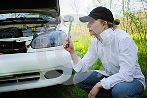 The girl`s car broke down, vehicle repair