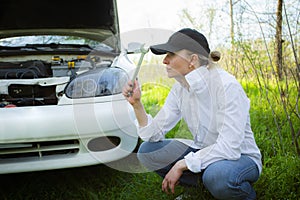 The girl`s car broke down, vehicle repair