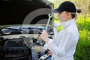 The girl`s car broke down, vehicle repair