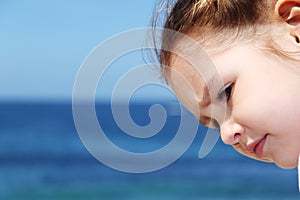 Girl's face with deep blue ocean backgroun
