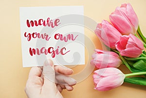 Girl`s hand holding card with inspirational quote