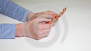 Girl`s hand rolling blister with pills.