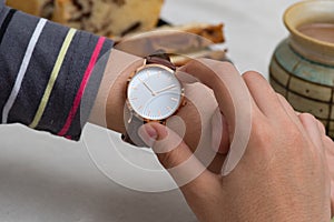 Girl`s hand with wrist watches at the coffee break