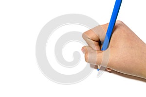 Girl`s hand writing with a blue pencil