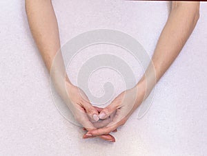 The girl`s hands with extended manicure  on a bright table