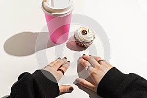 The girl`s hands are in front of a cake