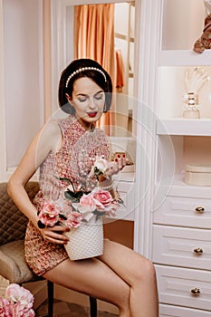 Girl`s home party at dressing room with many flowers
