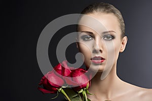 Girl's low key portrait with roses