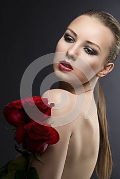 Girl's low key portrait with roses