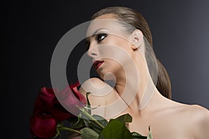Girl's low key portrait with roses