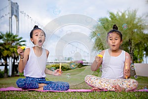 Girl`s play and Enjoy activities Blow bubbles in the park , Friend