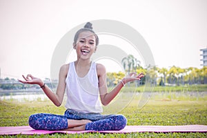 Girl`s practicing yoga in the park Strengthens concentration an photo