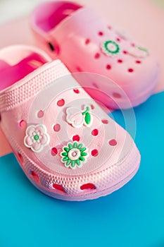 Girl`s rubber sandals isolated on the bright background.Kids beach shoes. Colorful footwear. aqua shoe for tropical