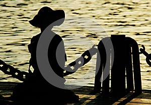 Girl's silhouette by water