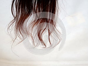 A girl& x27;s very beautiful hair is banging inside the day and the background is white behind