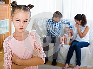 Girl sad because of jealous younger sister to parents