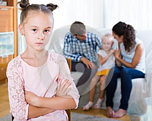 Girl sad because of jealous younger sister to parents