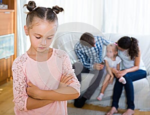 Girl sad because of jealous younger sister to parents