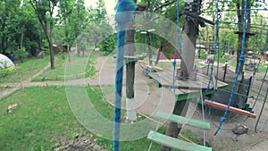 Girl in safety equipment in rope park